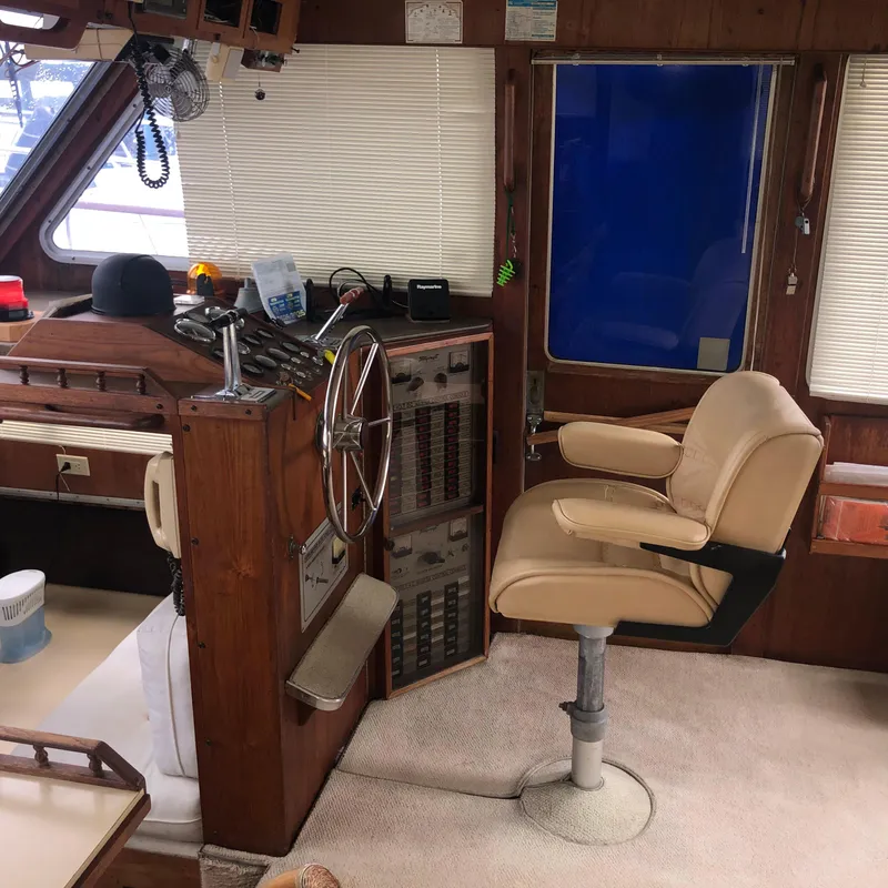 Slide: The Image of 1976 Tollycraft 48 Cockpit Motor Yacht helm with steering wheel and captain's chair. - 17