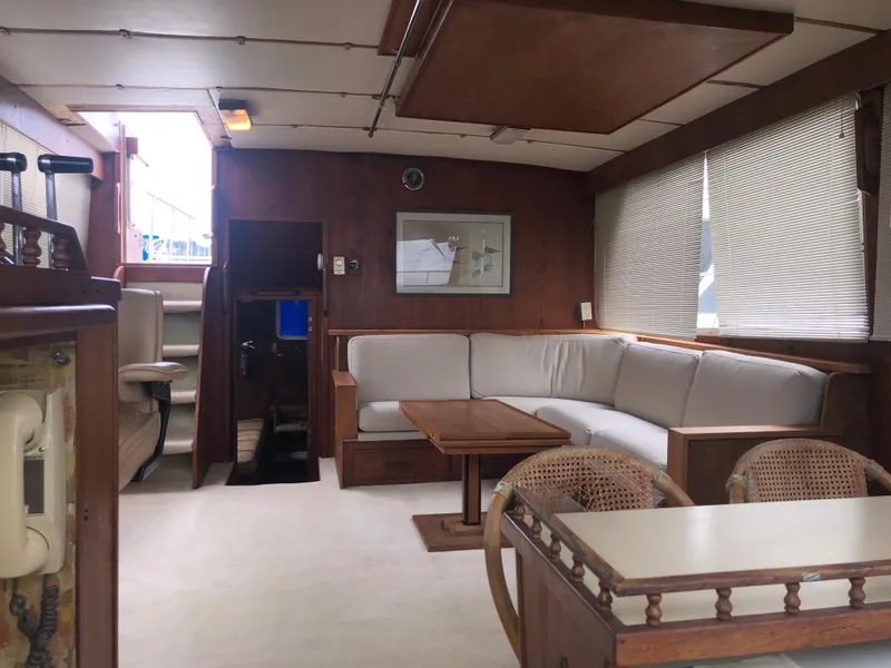 Slide: The Image of Interior of 1976 Tollycraft 48 Cockpit Motor Yacht with cozy seating and wooden accents. - 22