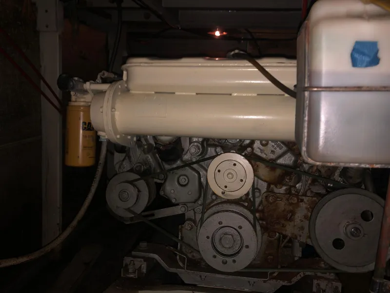 Slide: The Image of Engine compartment of a 1976 Tollycraft 48 Cockpit Motor Yacht, featuring visible belts and components. - 35