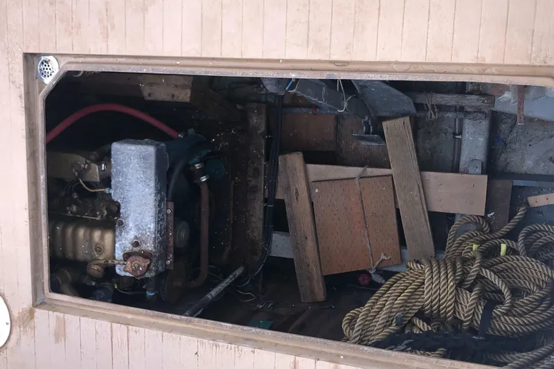Slide: The Image of 1976 Tollycraft 48 Cockpit Motor Yacht engine compartment with ropes and wooden planks. - 36