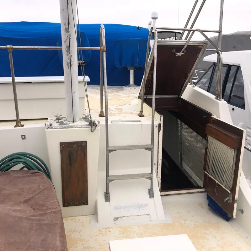 Slide: The Image of 1976 Tollycraft 48 Cockpit Motor Yacht deck with ladder and open hatch. - 7