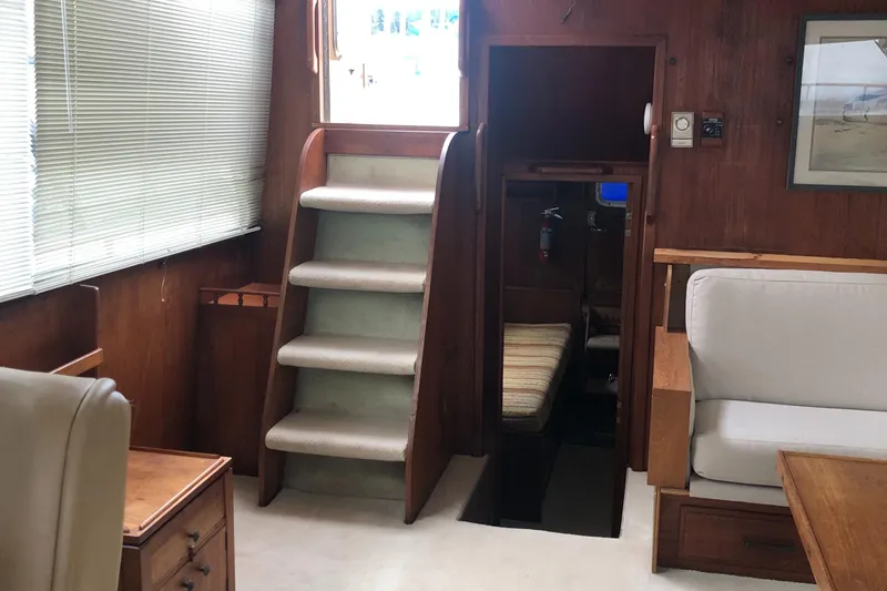 Slide: The Image of Interior of 1976 Tollycraft 48 Cockpit Motor Yacht with wooden paneling and carpeted stairs. - 8