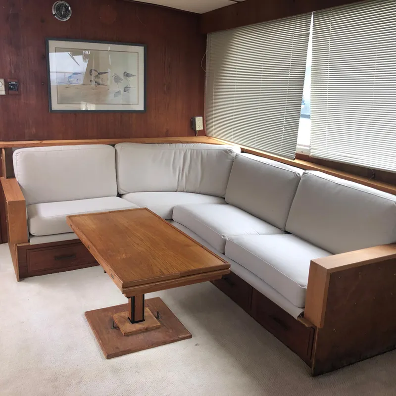Slide: The Image of Interior of 1976 Tollycraft 48 Cockpit Motor Yacht with cozy seating and wooden table. - 9
