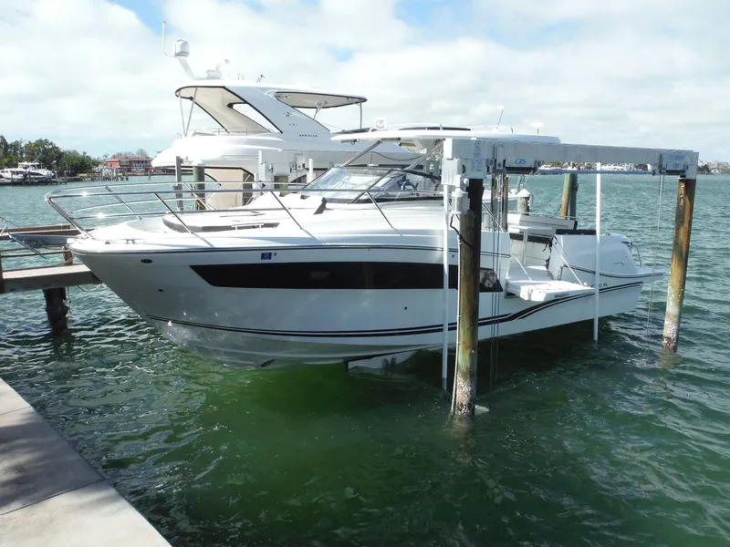 Slide: The Image of 2023 Jeanneau Leader 10.5 WA Series 2 boat docked on water lift. - 1