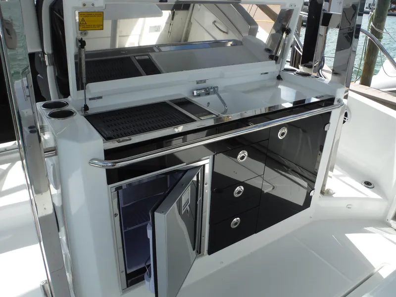 Slide: The Image of 2023 Jeanneau Leader 10.5 WA Series 2 yacht kitchen area with sleek cabinetry. - 21