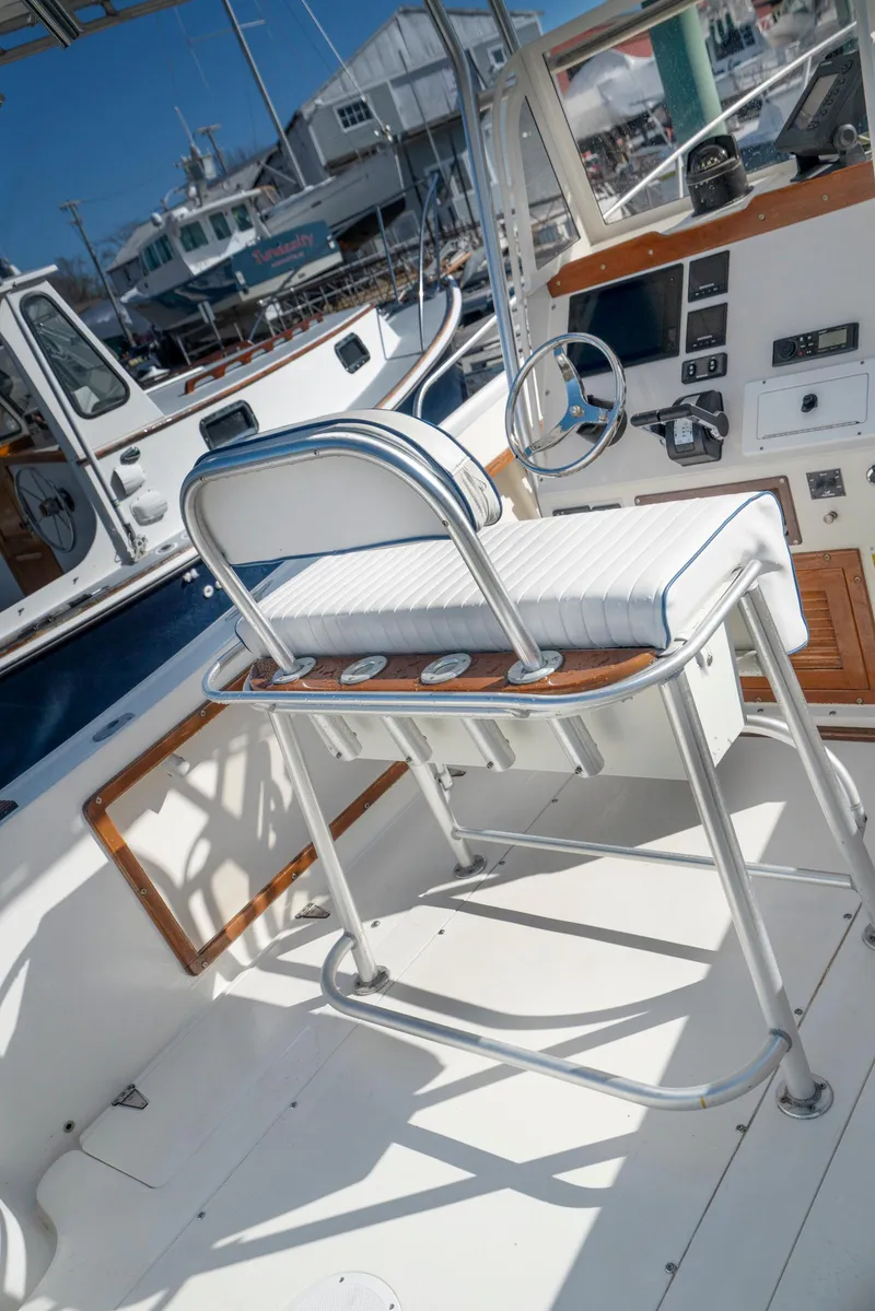 Slide: The Image of 1990 Mako 261 Center Console boat interior with helm and seating. - 16
