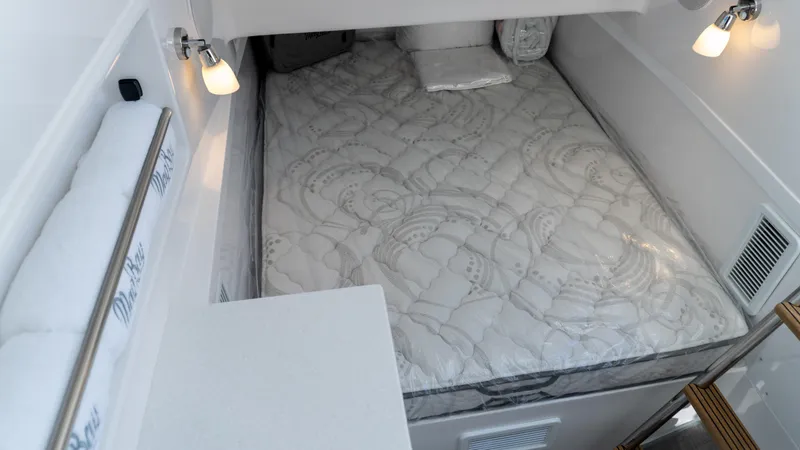 Slide: The Image of 2026 Mag Bay 43 CC cabin interior with cozy bed and modern lighting. - 11