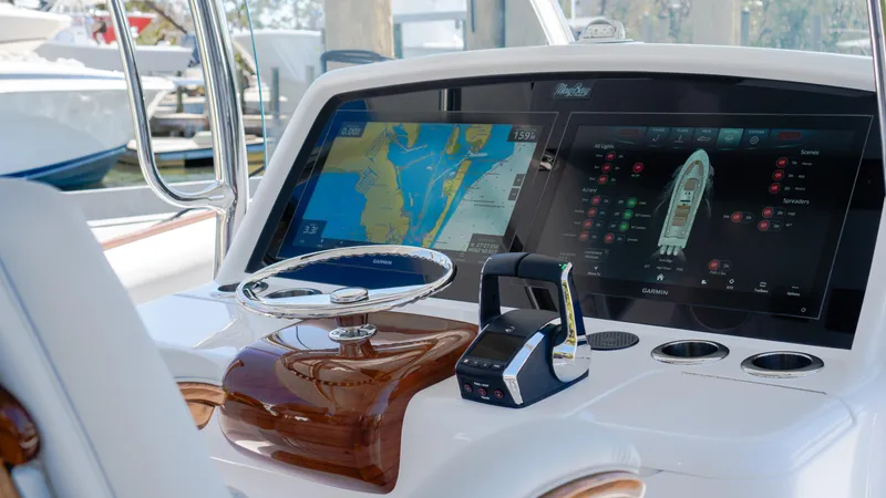 Slide: The Image of 2026 Mag Bay 43 CC helm with advanced navigation displays and controls. - 16