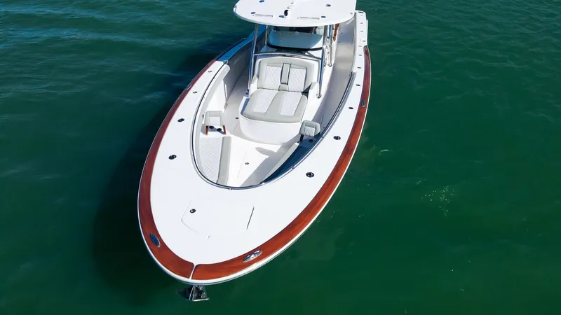 Slide: The Image of 2026 Mag Bay 43 CC boat on clear water, showcasing sleek design and spacious deck. - 3