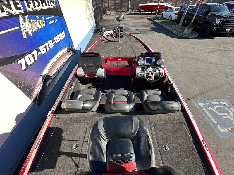 Slide: The Image of 2008 Nitro Z9 boat interior with seating and control panel, parked outdoors. - 11