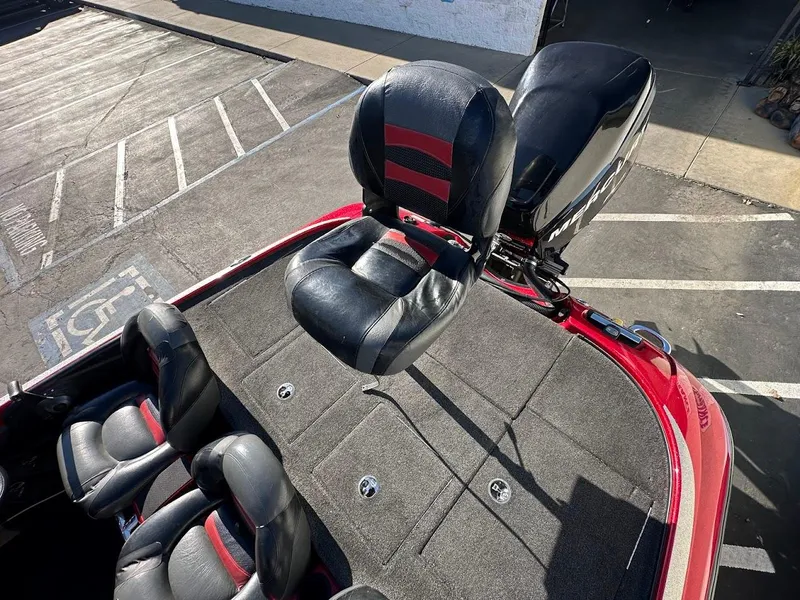 Slide: The Image of 2008 Nitro Z9 boat with black and red seating, parked on pavement. - 12