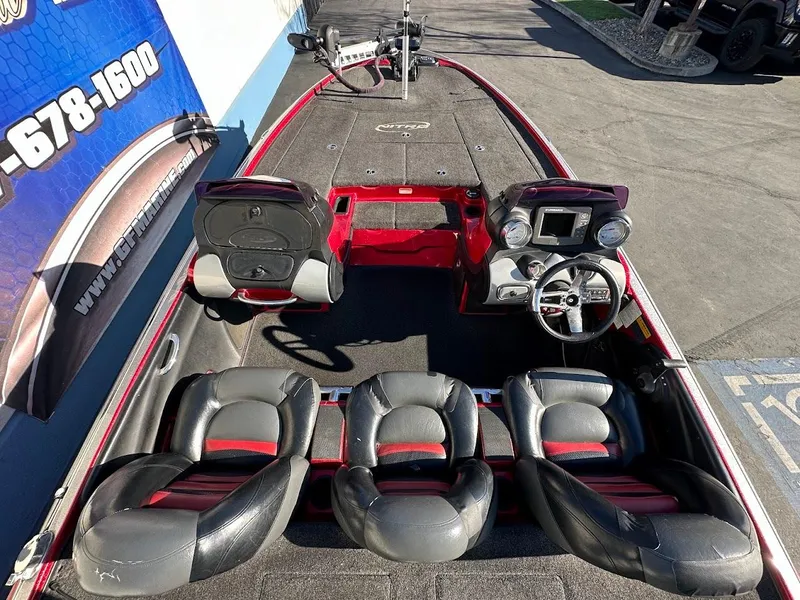 Slide: The Image of 2008 Nitro Z9 boat interior with seating and steering console, parked outdoors. - 13