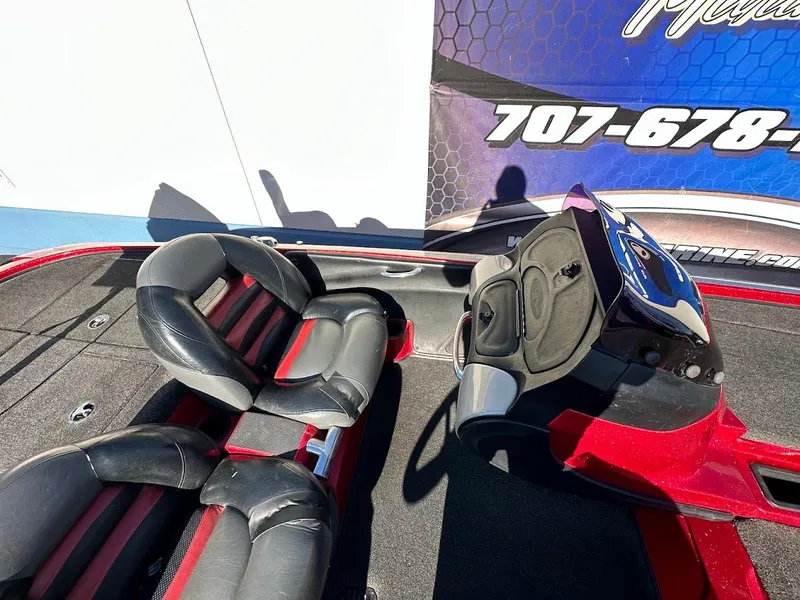 Slide: The Image of 2008 Nitro Z9 boat interior with black and red seats, steering console, and carpeted flooring. - 15