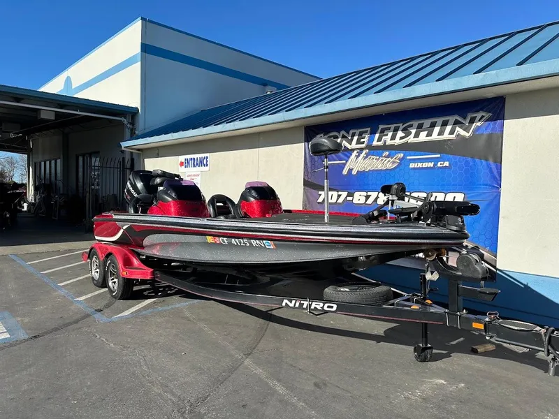 Slide: The Image of 2008 Nitro Z9 boat on trailer outside a fishing store. - 2