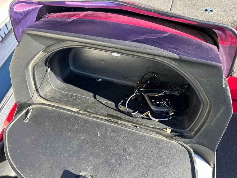 Slide: The Image of Open storage compartment in a 2008 Nitro Z9 boat with cables inside. - 24