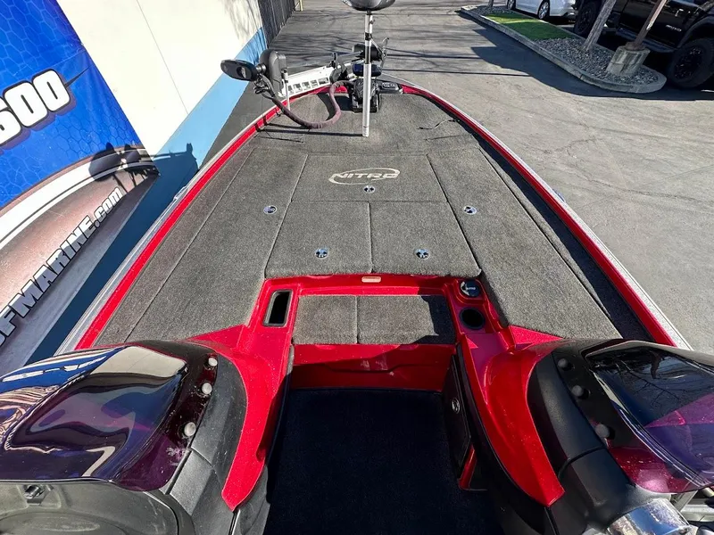 Slide: The Image of 2008 Nitro Z9 boat deck with red trim and fishing equipment. - 25