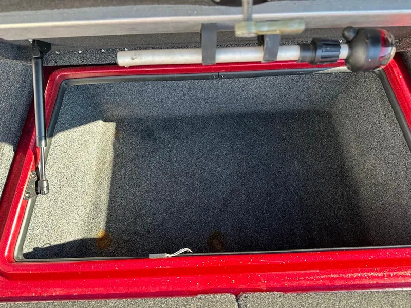 Slide: The Image of Open storage compartment in 2008 Nitro Z9 boat, featuring red trim and carpeted interior. - 32