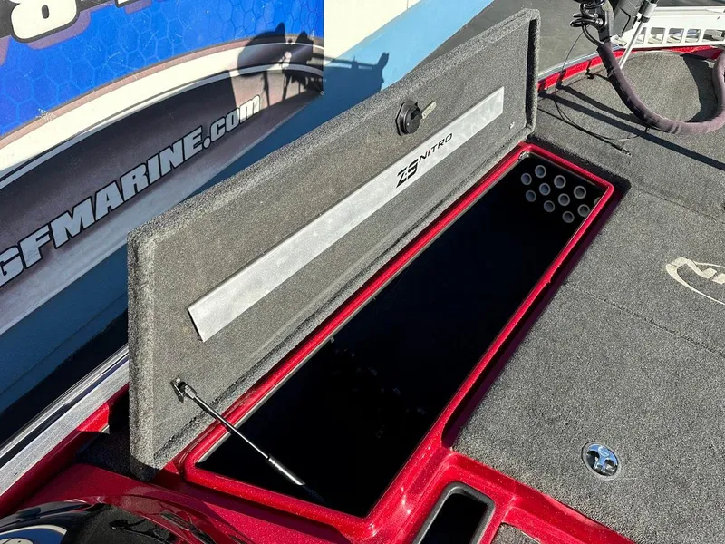 Slide: The Image of Open storage compartment on a 2008 Nitro Z9 boat, featuring carpeted interior. - 33