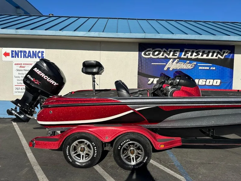 Slide: The Image of Red 2008 Nitro Z9 boat with Mercury engine on trailer, parked outside a fishing store. - 7