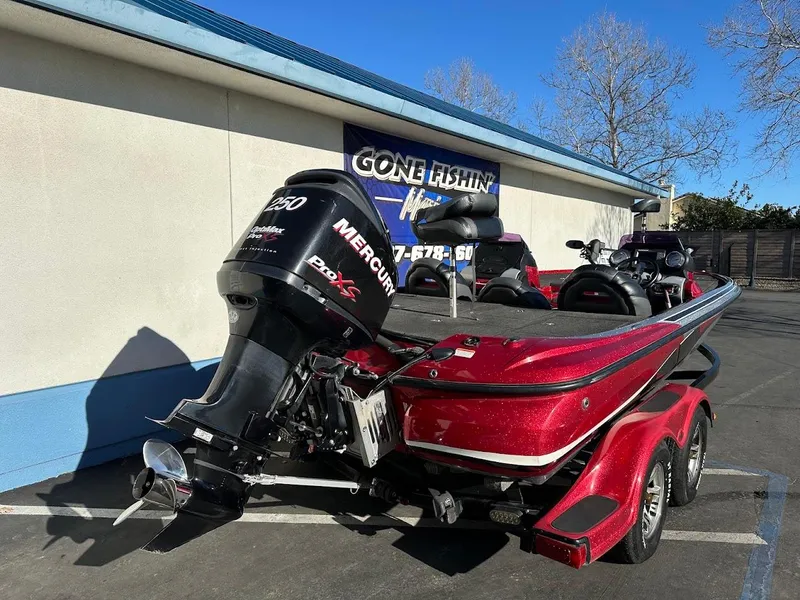 Slide: The Image of Red 2008 Nitro Z9 boat with Mercury engine parked outside a fishing store. - 9