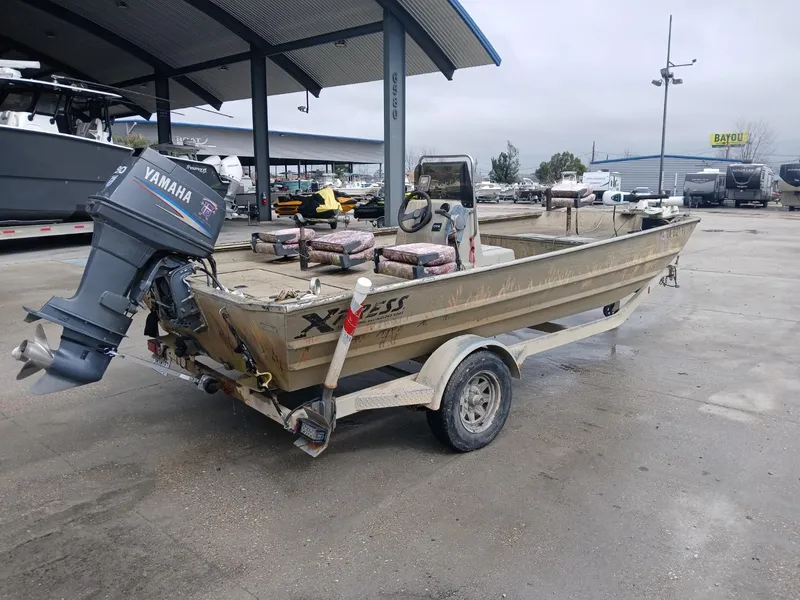 Slide: The Image of 2004 Xpress 18 boat with Yamaha outboard motor on trailer at marina. - 10