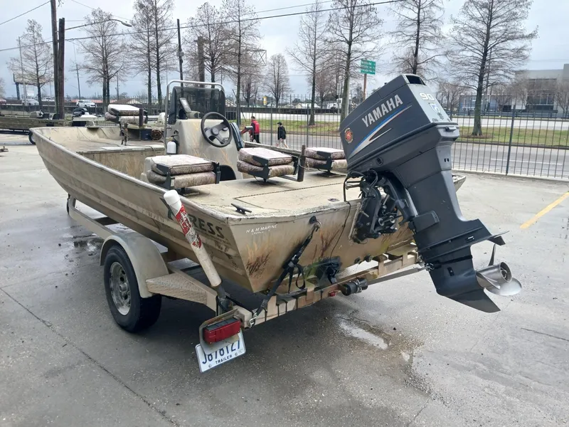 Slide: The Image of 2004 Xpress 18 boat with Yamaha outboard motor on a trailer. - 9
