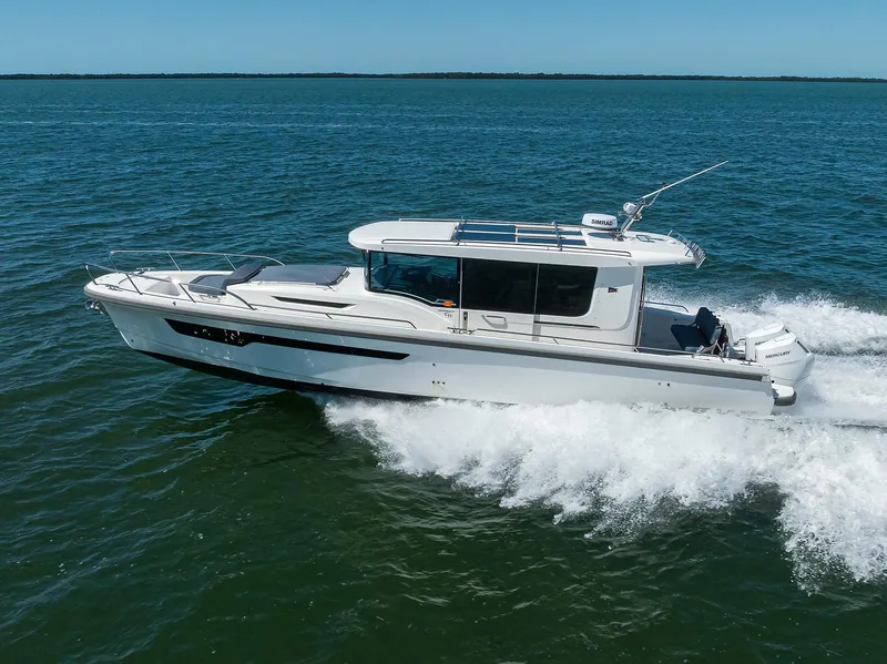 Slide: The Image of 2024 Nimbus C11 boat cruising on open water under clear blue skies. - 15