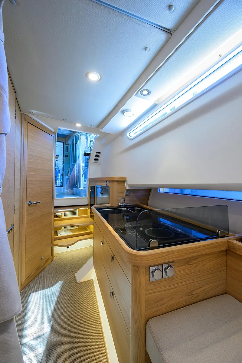 Slide: The Image of 2024 Nimbus C11 yacht interior with modern kitchen and wooden cabinetry. - 45
