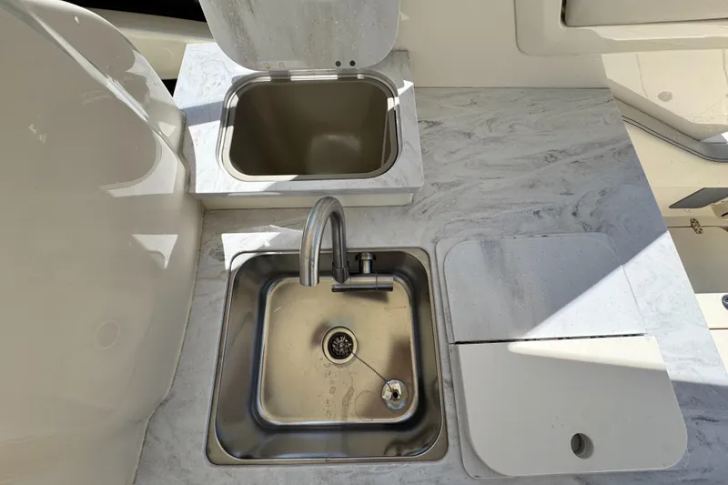 Slide: The Image of 2025 Scout 277 Dorado boat kitchen with stainless steel sink and countertop. - 12