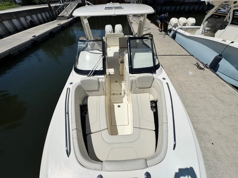 Slide: The Image of 2025 Scout 277 Dorado boat docked, showcasing spacious seating and sleek design. - 23