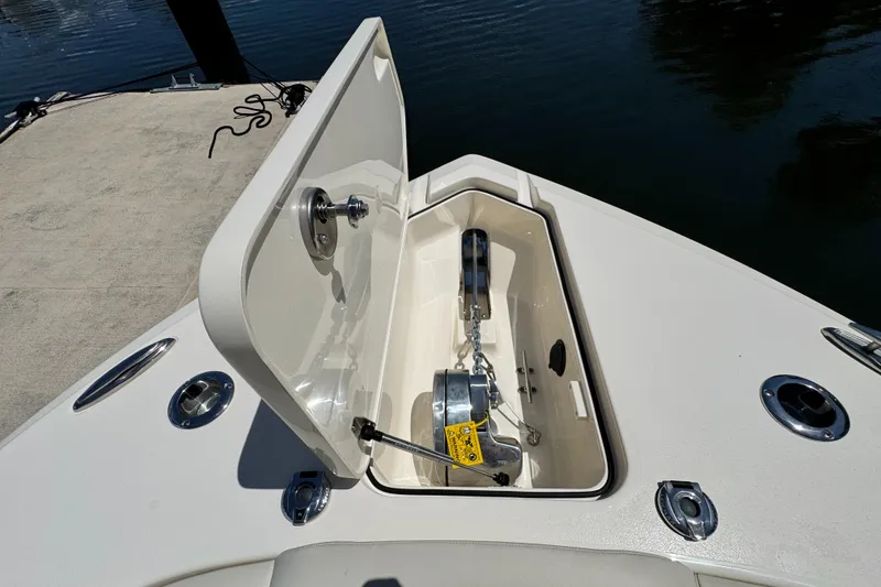 Slide: The Image of Anchor compartment of 2025 Scout 277 Dorado boat, open on a sunny day. - 26