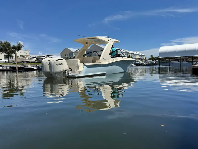 Slide: The Image of 2025 Scout 277 Dorado boat on calm water, featuring Yamaha outboard motor. - 4