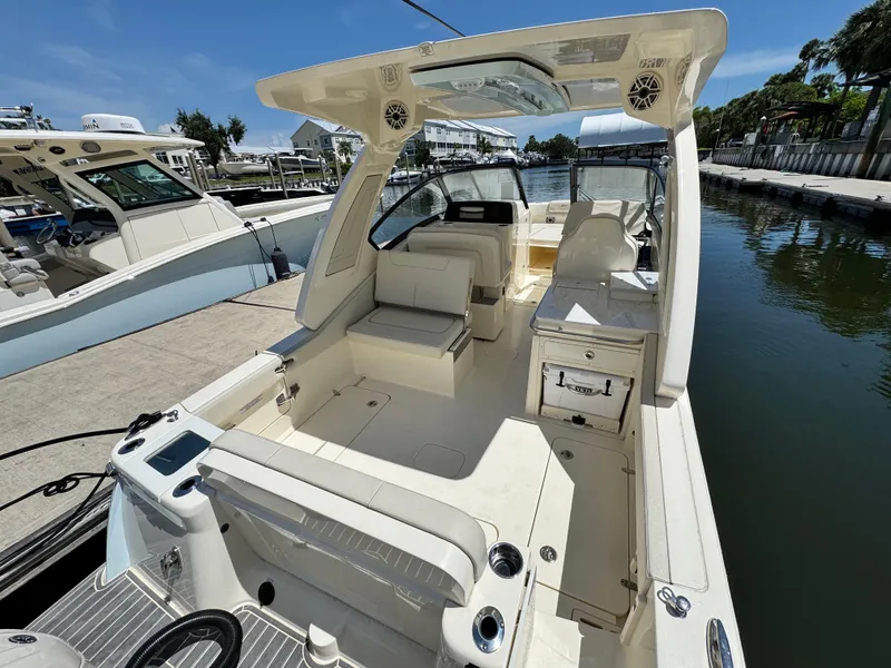 Slide: The Image of 2025 Scout 277 Dorado boat docked, showcasing spacious seating and modern design. - 7