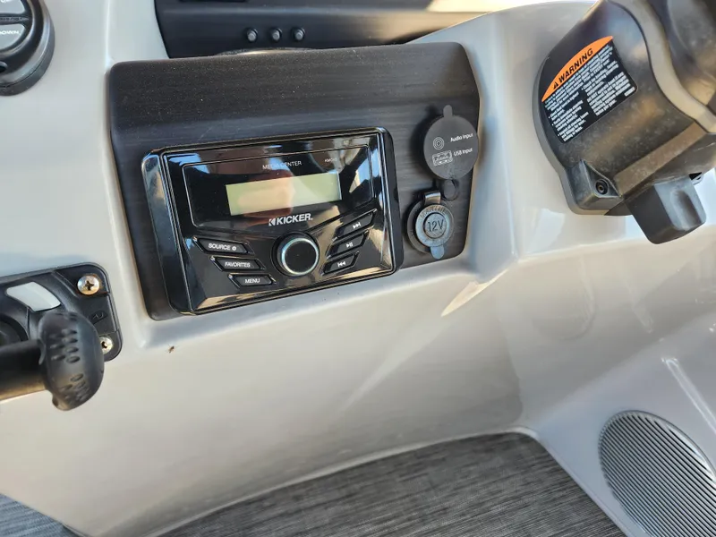 Slide: The Image of 2021 Bennington SX 21 L-Bench dashboard with Kicker stereo system and controls. - 17