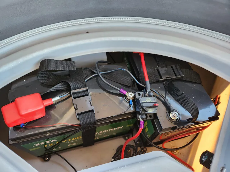 Slide: The Image of Battery compartment of 2021 Bennington SX 21 L-Bench with secured wiring and connections. - 18