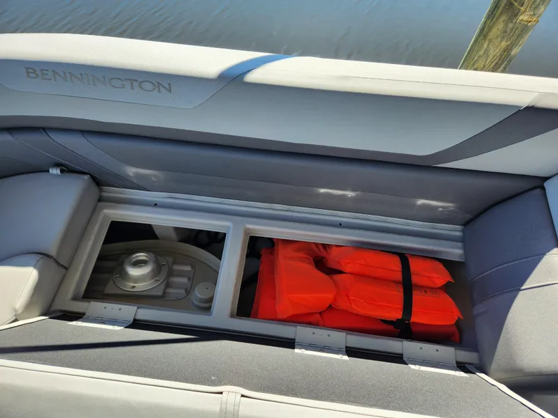 Slide: The Image of 2021 Bennington SX 21 L-Bench storage with life jackets and equipment. - 21