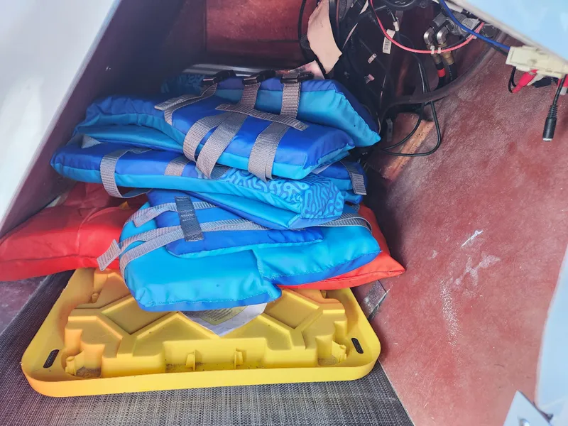 Slide: The Image of Storage compartment of 2021 Bennington SX 21 L-Bench with life jackets and equipment. - 23