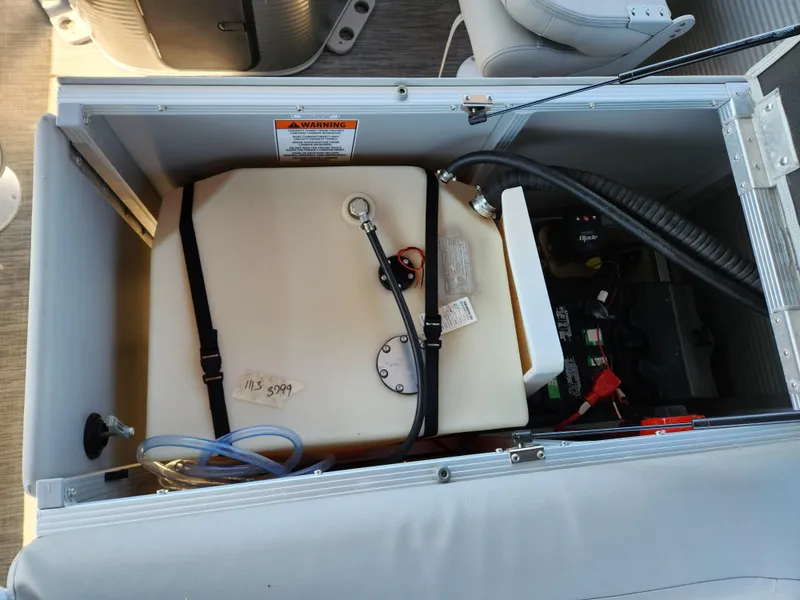 Slide: The Image of 2021 Bennington SX 21 L-Bench storage compartment with fuel tank and battery. - 28