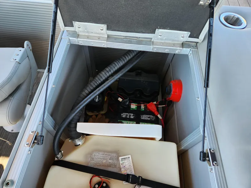 Slide: The Image of 2021 Bennington SX 21 L-Bench storage compartment with battery and wiring. - 30