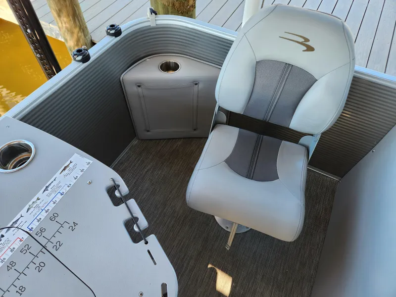Slide: The Image of 2021 Bennington SX 21 L-Bench boat interior with gray seating and cup holders. - 32