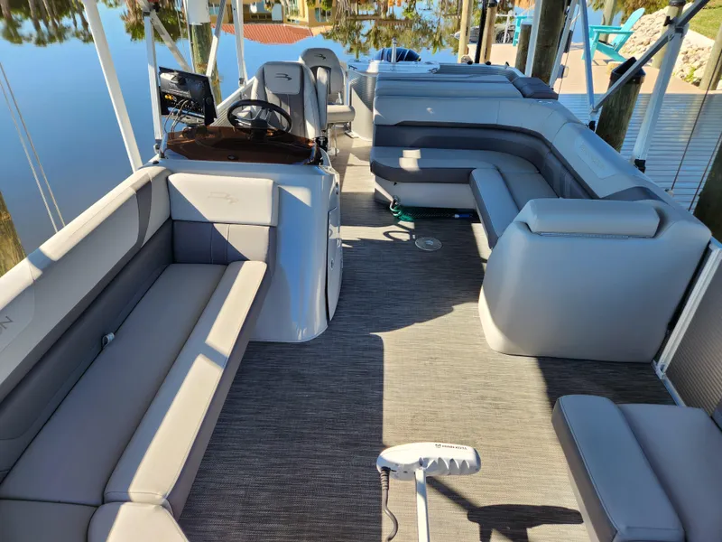 Slide: The Image of 2021 Bennington SX 21 L-Bench pontoon boat interior with spacious seating and modern design. - 6