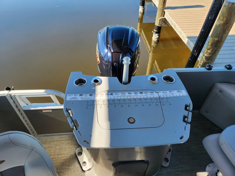 Slide: The Image of 2021 Bennington SX 21 L-Bench boat with motor, docked on calm water. - 9