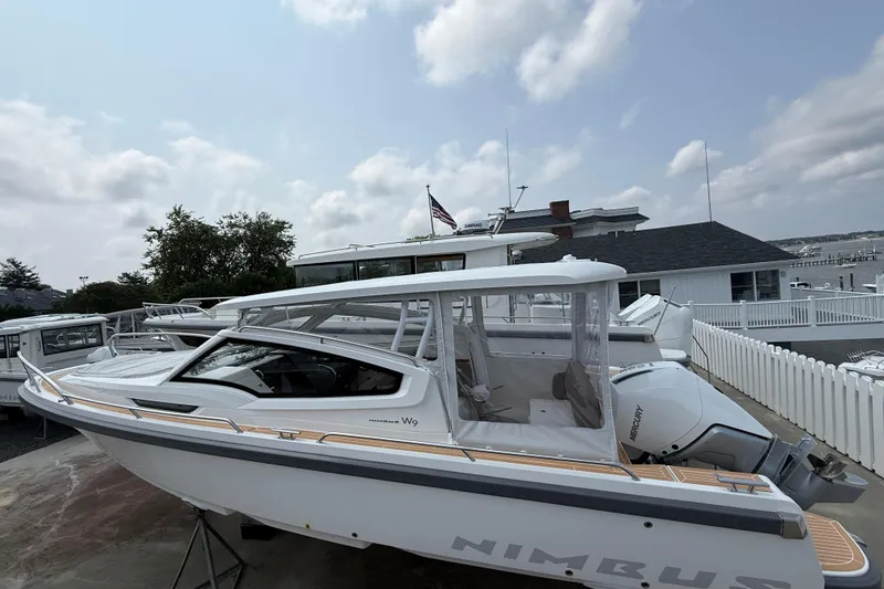 The Image of 2025 Nimbus Weekender 9 boat docked, featuring sleek design and modern outboard motor. - 0