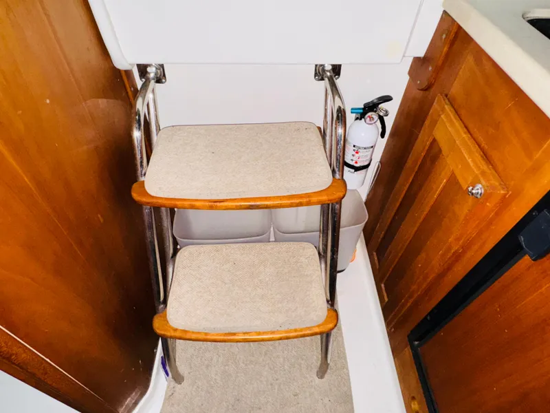Slide: The Image of Interior steps of 2006 Back Cove Hardtop Express with fire extinguisher nearby. - 16