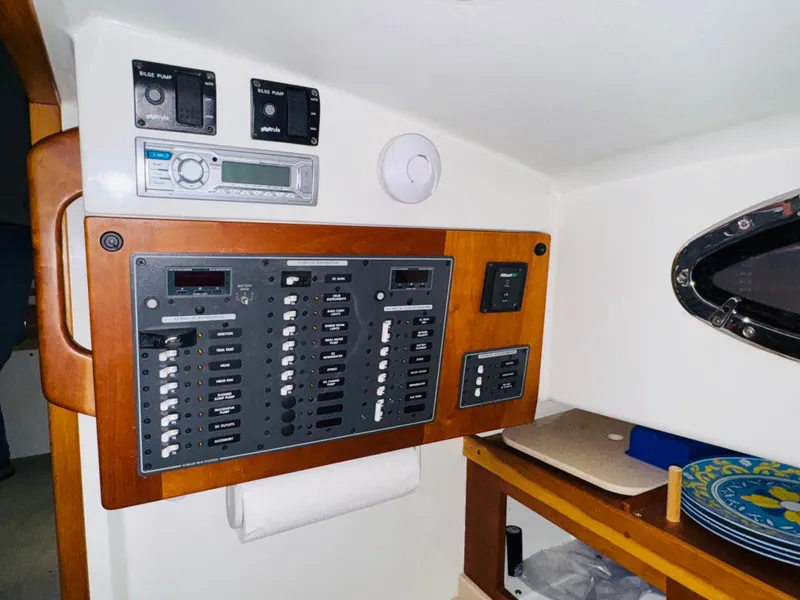 Slide: The Image of Electrical panel inside 2006 Back Cove Hardtop Express boat cabin. - 17