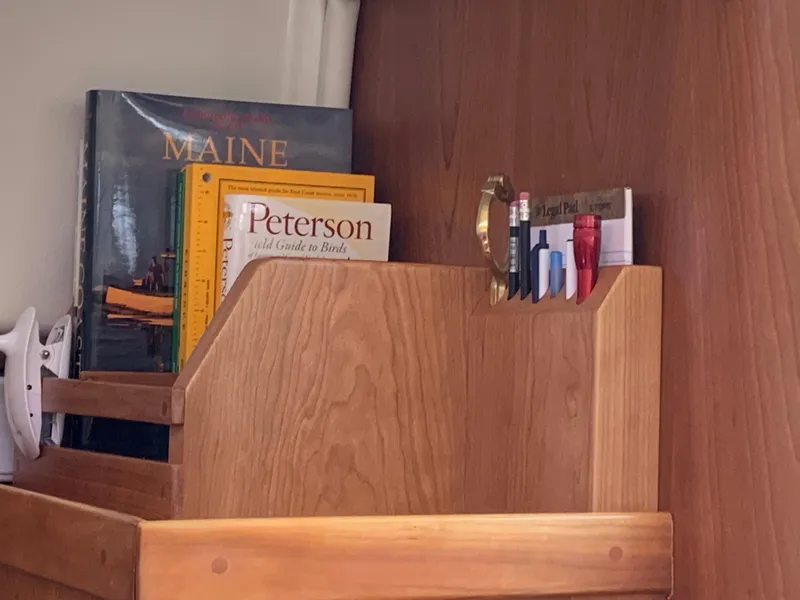 Slide: The Image of Wooden shelf with books and pens on a 2006 Back Cove Hardtop Express boat. - 19