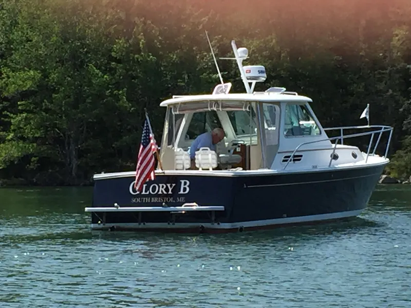 Slide: The Image of 2006 Back Cove Hardtop Express boat on water, displaying American flag. - 24