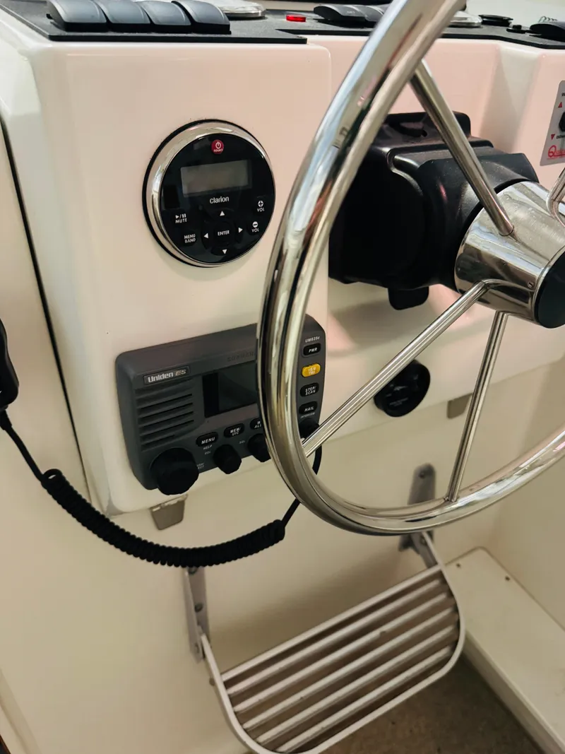 Slide: The Image of 2006 Back Cove Hardtop Express helm with steering wheel and control panel. - 5