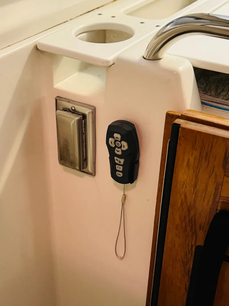 Slide: The Image of 2006 Back Cove Hardtop Express interior with remote control and cup holder. - 8