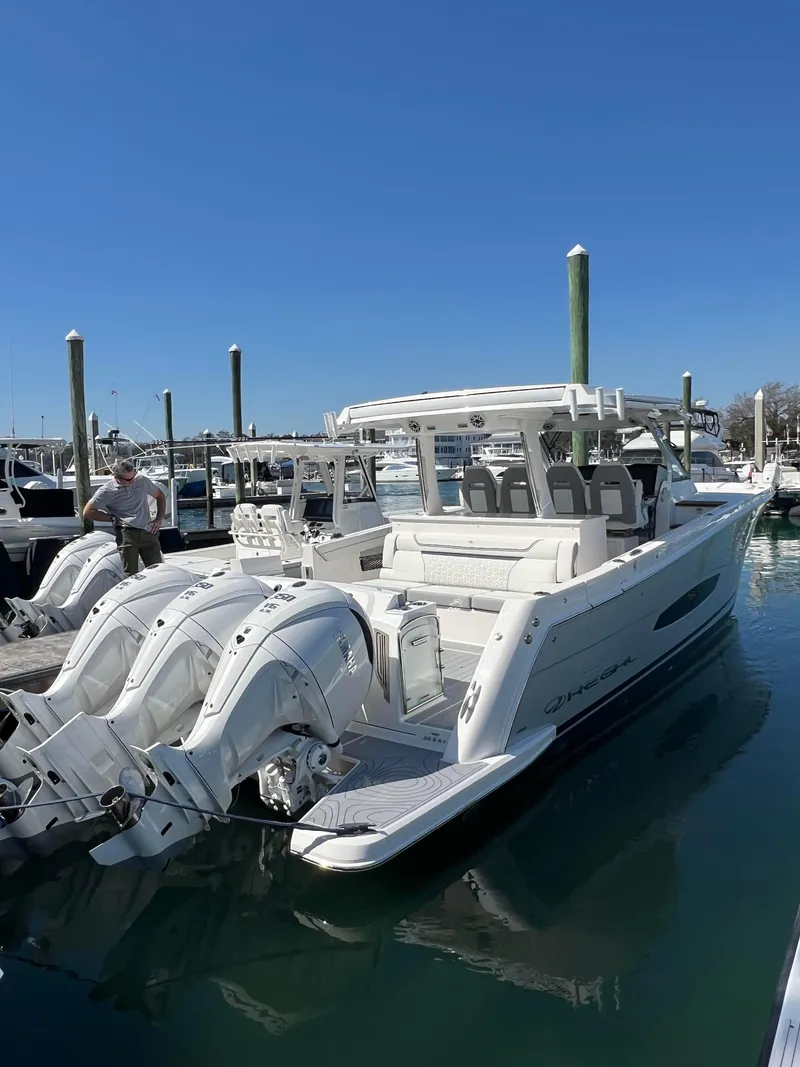 Slide: The Image of 2025 Regal 38 SAV boat with triple engines on calm water. - 2